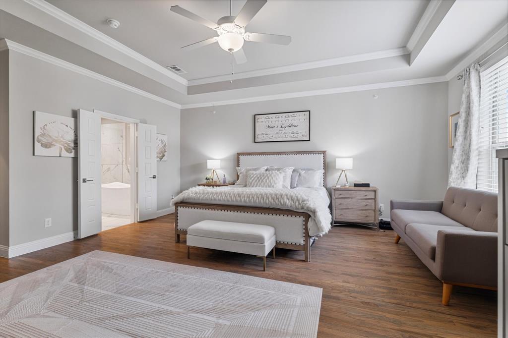 6013 Page Street Frisco, TX 75034 - Photo 27 of 38 a spacious bedroom with a bed a couch and a window