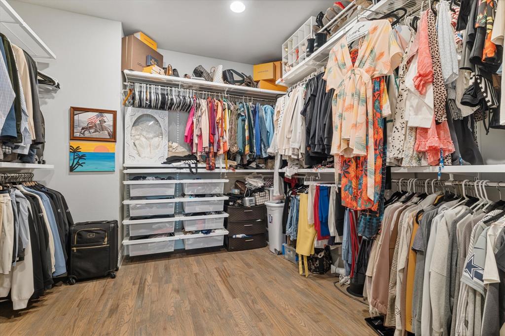 6013 Page Street Frisco, TX 75034 - Photo 31 of 38 a view of walk in closet with clothes and shoes