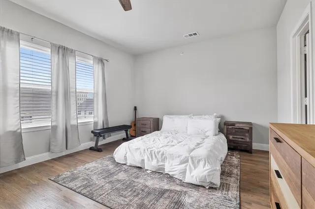 a bedroom with a bed and a large window