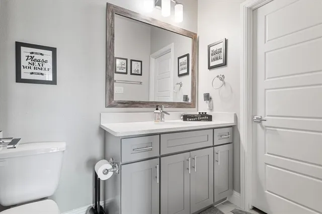 a bathroom with a toilet sink and mirror