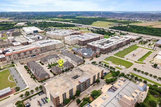 an aerial view of a building with an outdoor space and seating area