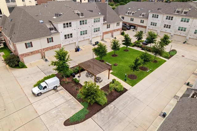 an aerial view of a house with garden space and street view