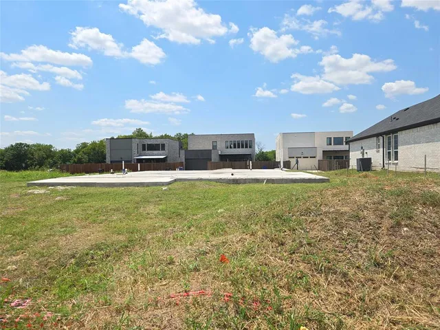 a house view with swimming pool and trees in the background