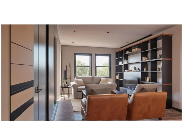 a living room with furniture window and a wooden floor