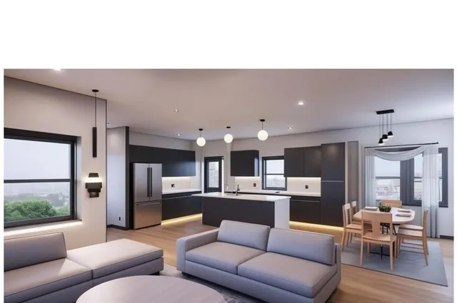 a living room with furniture and kitchen view