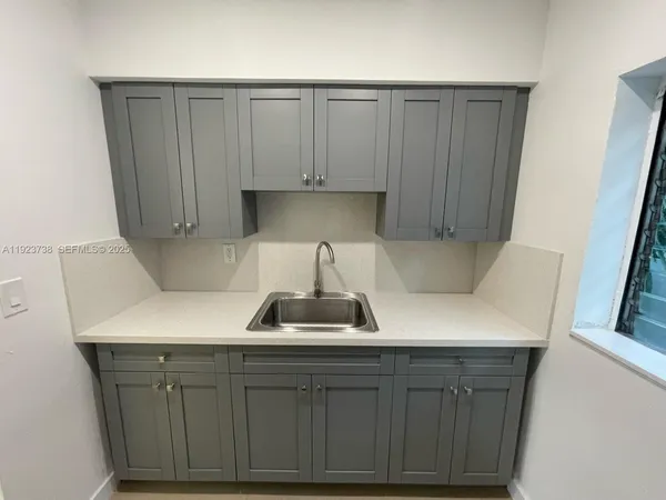 a kitchen with a sink and cabinets