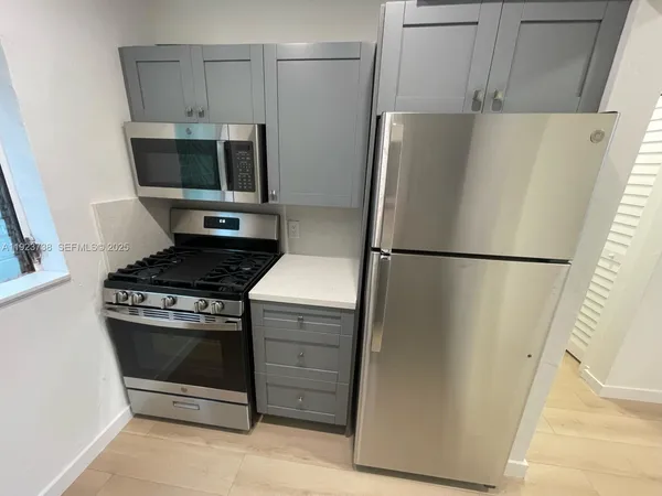 a kitchen with a refrigerator and a stove