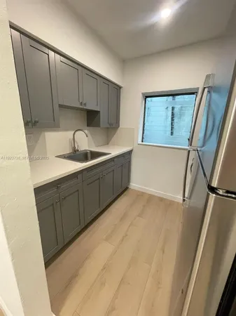 a kitchen with a sink and cabinets
