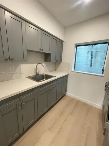 a kitchen with a sink and cabinets