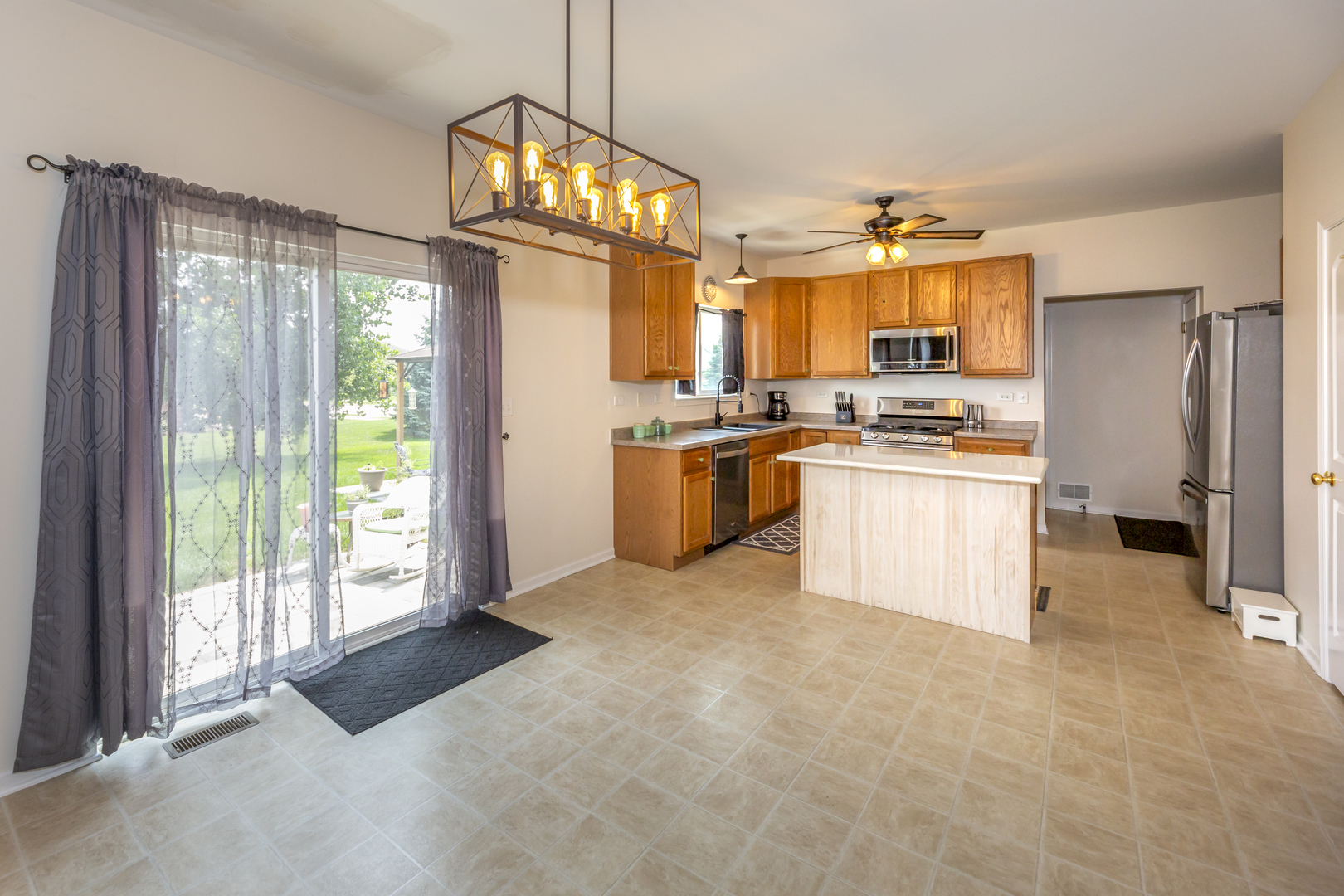 412 Preserve Drive Genoa, IL 60135 - Photo 15 of 39 a kitchen with stainless steel appliances granite countertop a stove top oven a sink and a refrigerator
