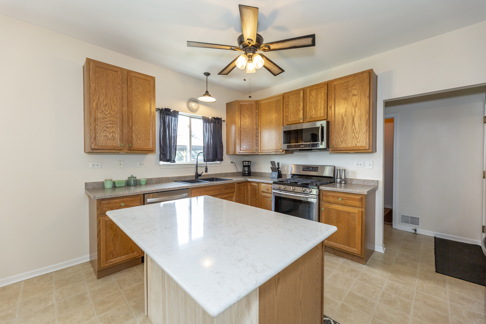412 Preserve Drive Genoa, IL 60135 - Photo 16 of 39 a kitchen with stainless steel appliances granite countertop a sink a stove top oven a counter space and cabinets