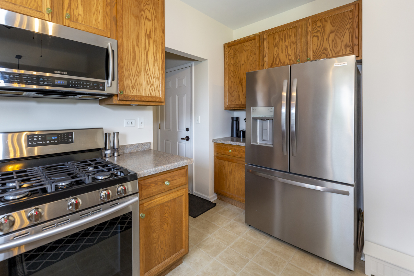 412 Preserve Drive Genoa, IL 60135 - Photo 19 of 39 a kitchen with stainless steel appliances granite countertop a refrigerator stove and microwave
