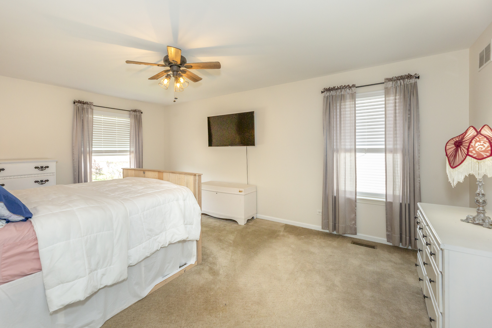 412 Preserve Drive Genoa, IL 60135 - Photo 26 of 39 a spacious bedroom with a bed and a flat screen tv