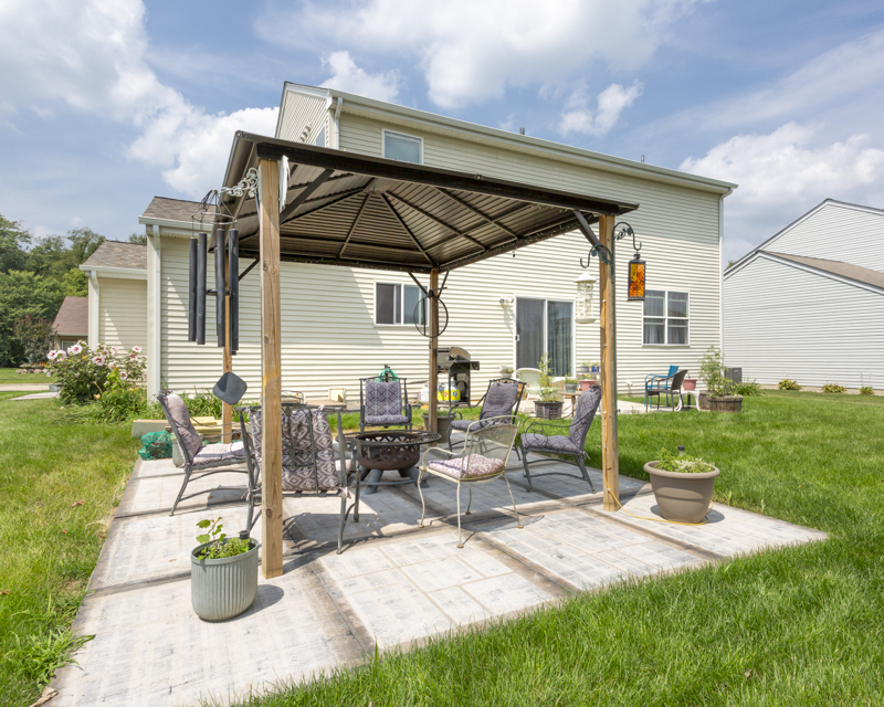 412 Preserve Drive Genoa, IL 60135 - Photo 5 of 39 a patio with a table and chairs and potted plants