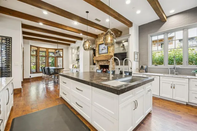 a kitchen with stainless steel appliances granite countertop a sink and dishwasher with wooden floor