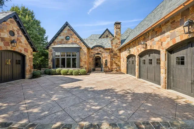 a front view of a house with a yard and potted plants