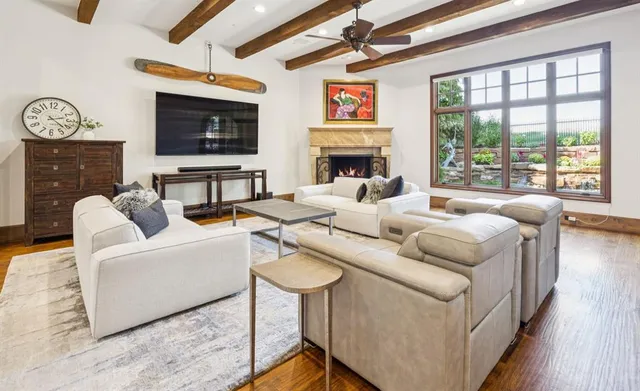 a living room with fireplace furniture and a flat screen tv