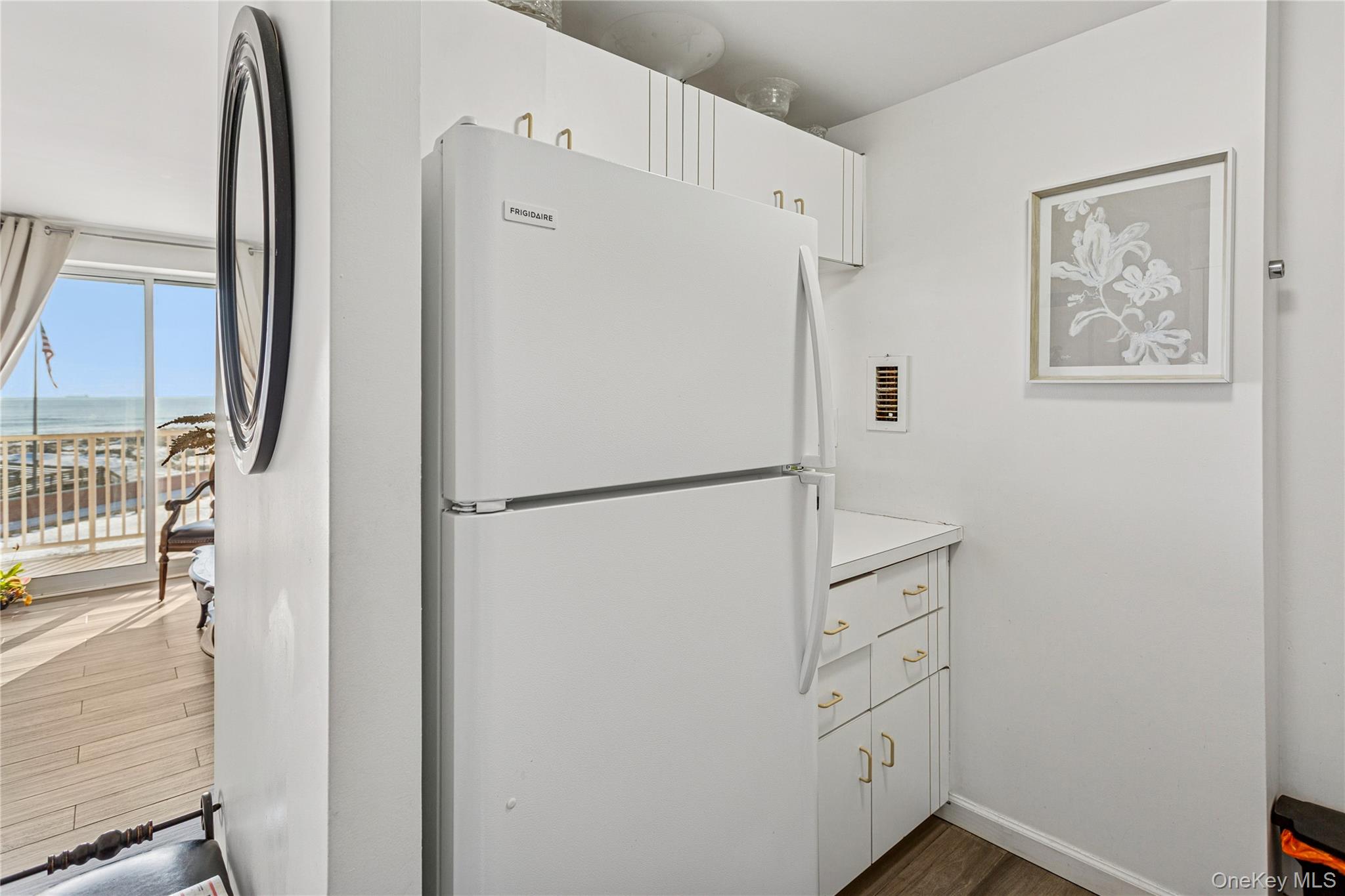 2 Richmond Road, Unit 3B Lido Beach, NY 11561 - Photo 11 of 17 a white refrigerator freezer and a wooden floor