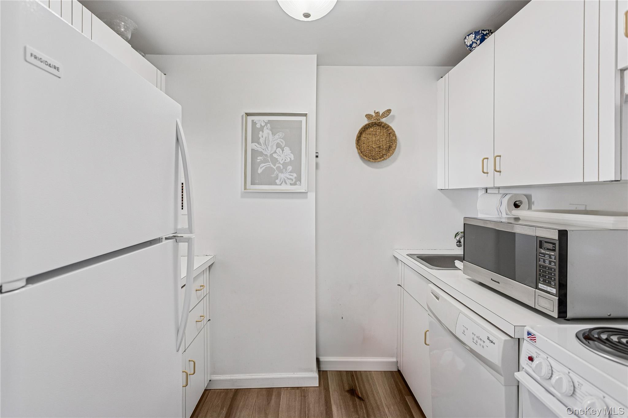 2 Richmond Road, Unit 3B Lido Beach, NY 11561 - Photo 9 of 17 a kitchen with a refrigerator and cabinets