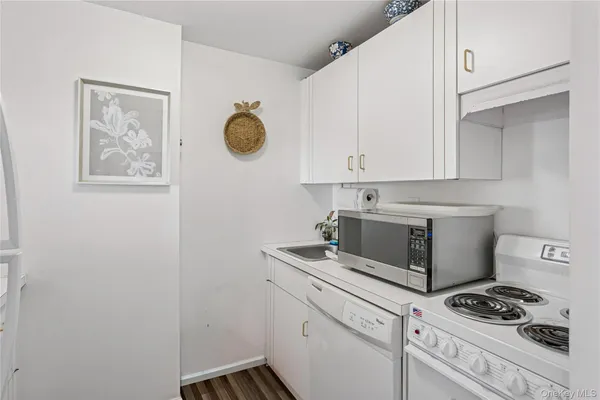 a white refrigerator freezer and a wooden floor