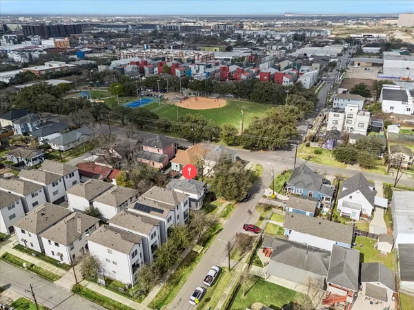 an aerial view of residential houses with outdoor space