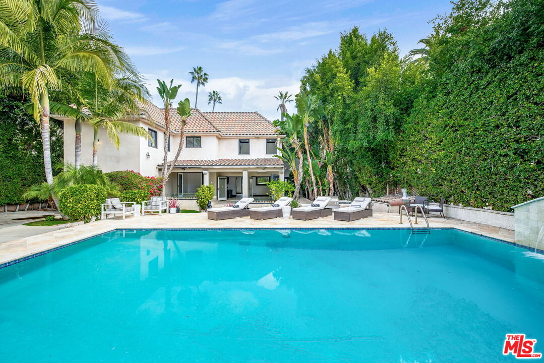 607 North Hillcrest Road Beverly Hills, CA 90210 - Photo 10 of 16 a view of swimming pool with outdoor seating and plants