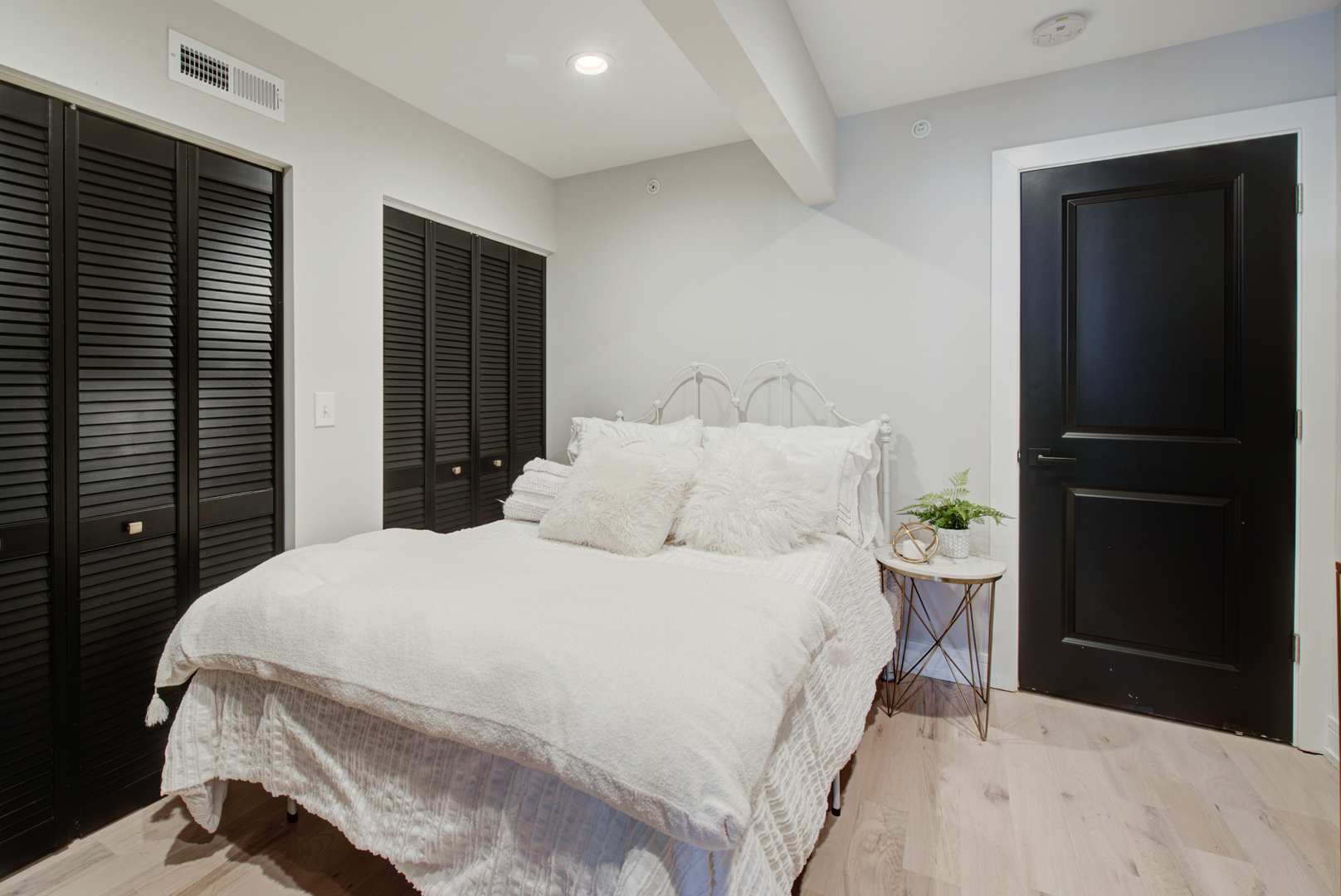 106 East Main Street St. Charles, IL 60174 - Photo 11 of 46 a bedroom with a bed and a potted plant