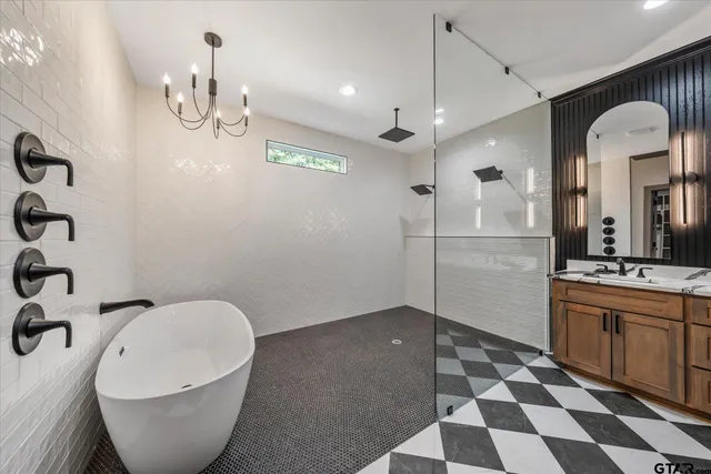 a spacious bathroom with a bathtub and a sink