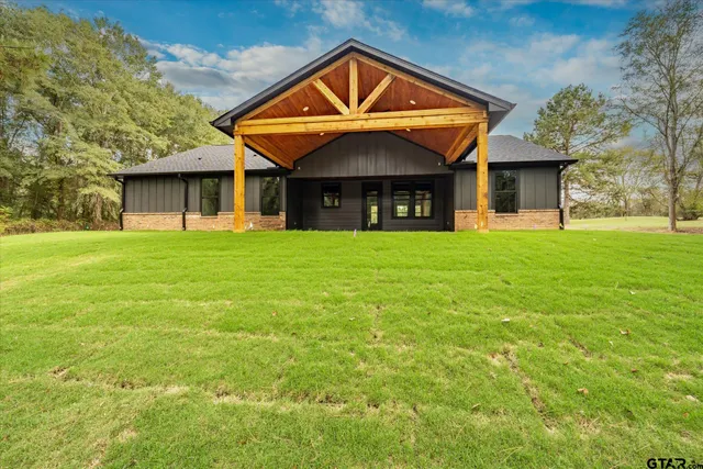 a front view of a house with yard and green space