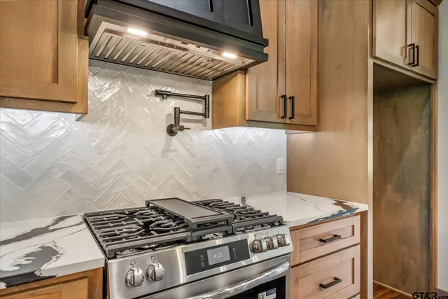 a stove top oven sitting inside of a kitchen
