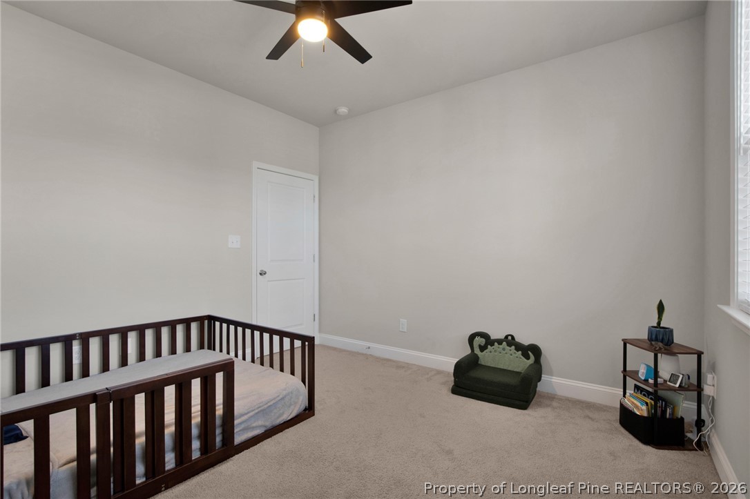 224 Timber Skip Drive Spring Lake, NC 28390 - Photo 20 of 30 a hallway with with two beds and a couch