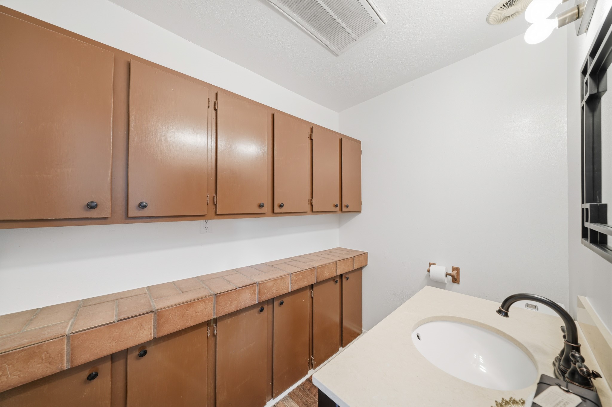 79 Summers Wind Street Conroe, TX 77356 - Photo 17 of 45 a close view of a sink and cabinets in a room