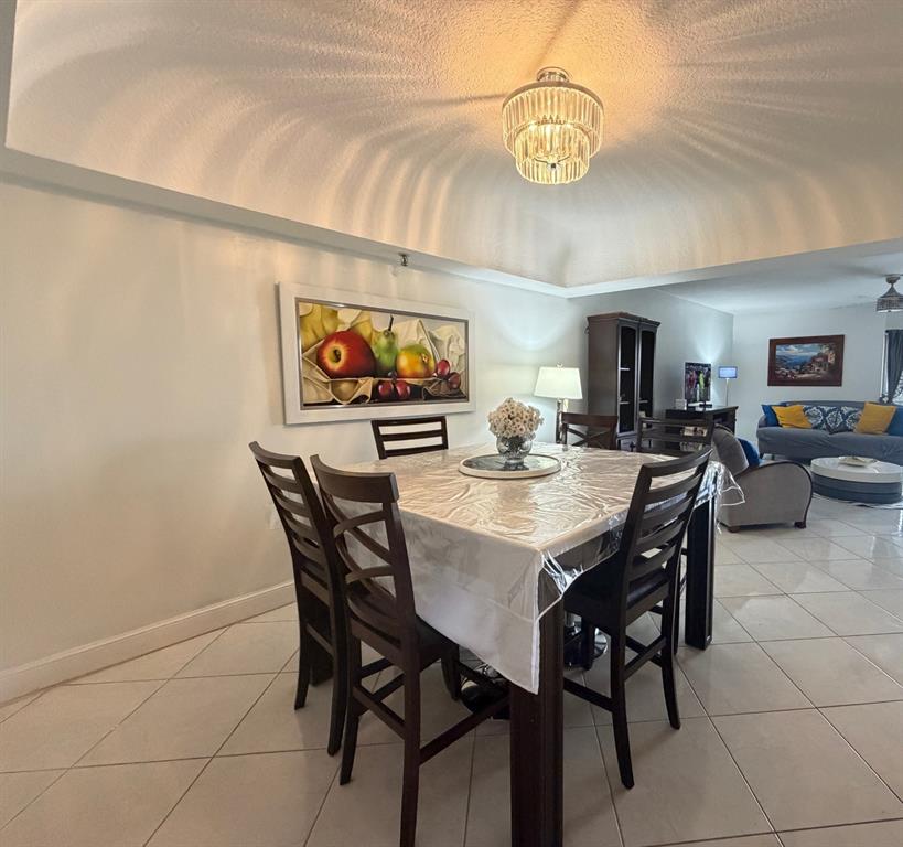 9170 Southwest 14th Street, Unit 4409 Boca Raton, FL 33428 - Photo 11 of 26 a view of a dining room with furniture