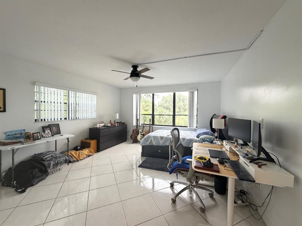 9170 Southwest 14th Street, Unit 4409 Boca Raton, FL 33428 - Photo 14 of 26 a living room with furniture and a window
