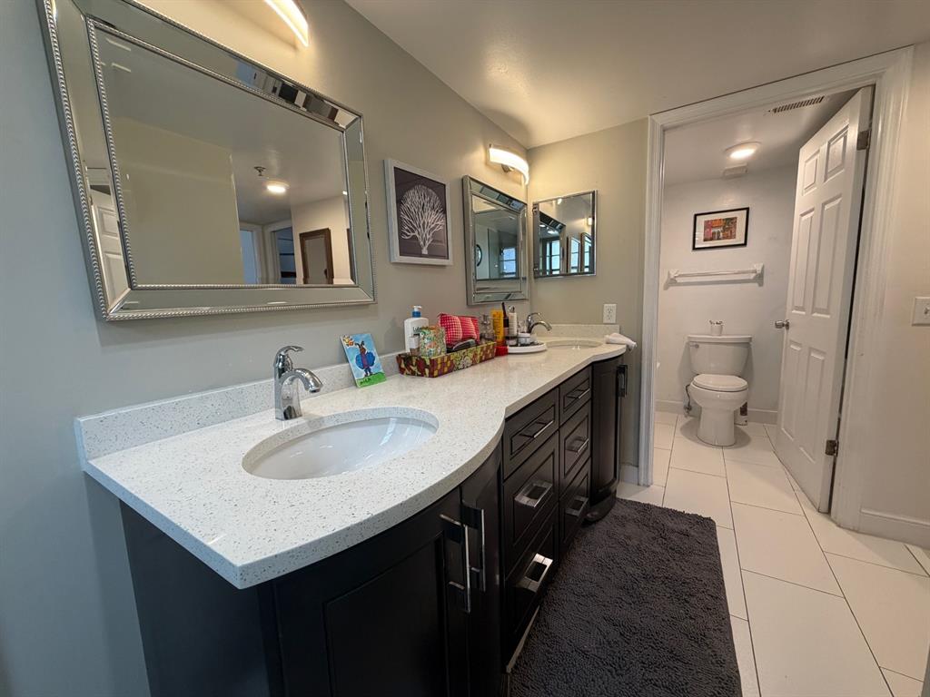 9170 Southwest 14th Street, Unit 4409 Boca Raton, FL 33428 - Photo 17 of 26 a bathroom with a sink double vanity and a mirror