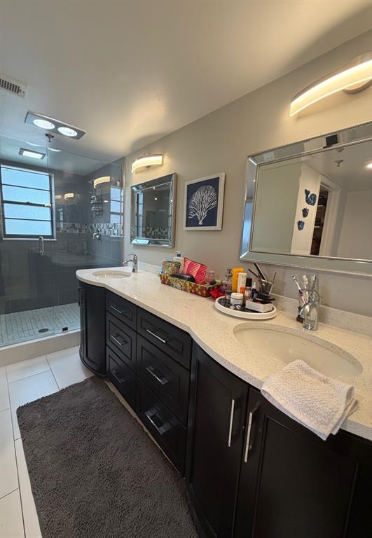 9170 Southwest 14th Street, Unit 4409 Boca Raton, FL 33428 - Photo 18 of 26 a bathroom with double vanity sinks a mirror and a shower