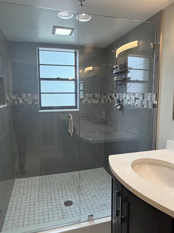 9170 Southwest 14th Street, Unit 4409 Boca Raton, FL 33428 - Photo 19 of 26 a bathroom with a sink shower and a mirror