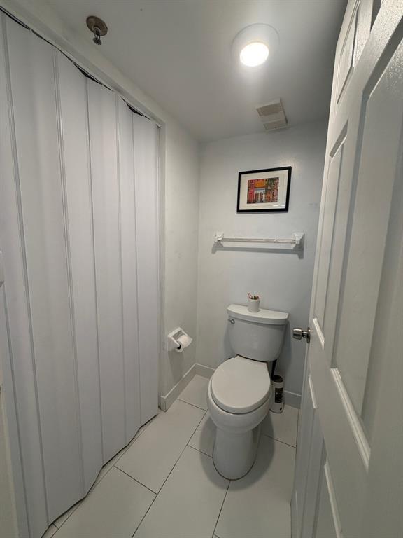 9170 Southwest 14th Street, Unit 4409 Boca Raton, FL 33428 - Photo 21 of 26 a white toilet sitting next to a small sink