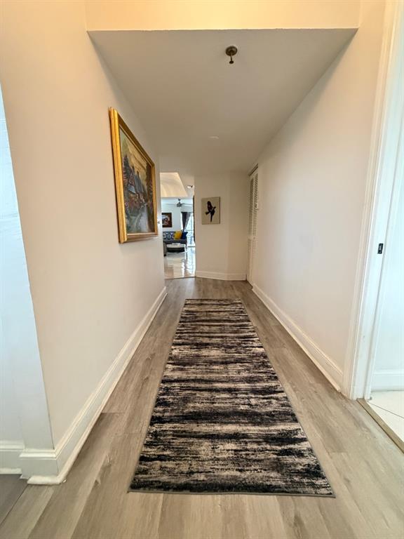 9170 Southwest 14th Street, Unit 4409 Boca Raton, FL 33428 - Photo 6 of 26 a view of a hallway with wooden floor and staircase
