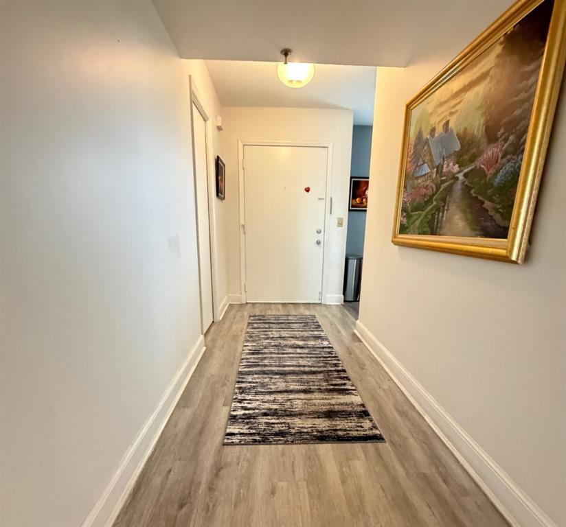 9170 Southwest 14th Street, Unit 4409 Boca Raton, FL 33428 - Photo 7 of 26 a view of a hallway with wooden floor and a bathroom