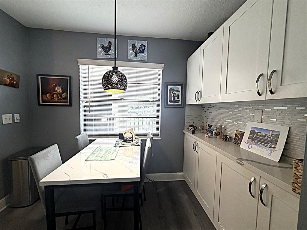 9170 Southwest 14th Street, Unit 4409 Boca Raton, FL 33428 - Photo 8 of 26 a kitchen with stainless steel appliances granite countertop a sink a stove a refrigerator a dining table and chairs