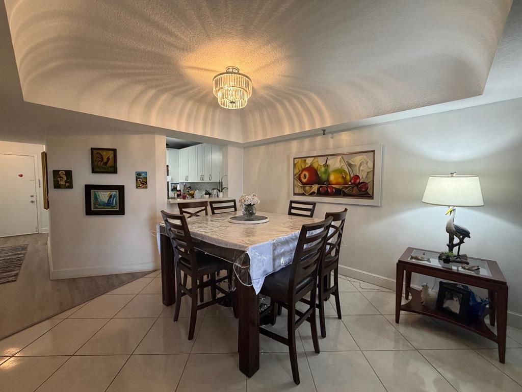 9170 Southwest 14th Street, Unit 4409 Boca Raton, FL 33428 - Photo 10 of 26 a view of a dining room with furniture and chandelier
