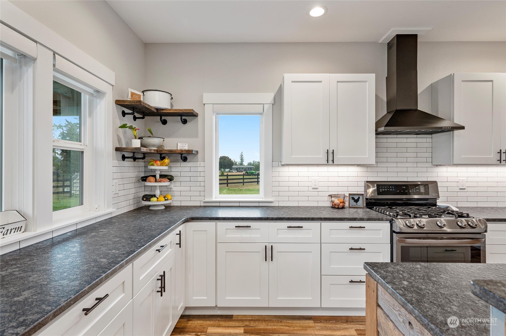 760 East Pole Road Lynden, WA 98264 - Photo 10 of 40 a kitchen with granite countertop a sink stainless steel appliances and cabinets