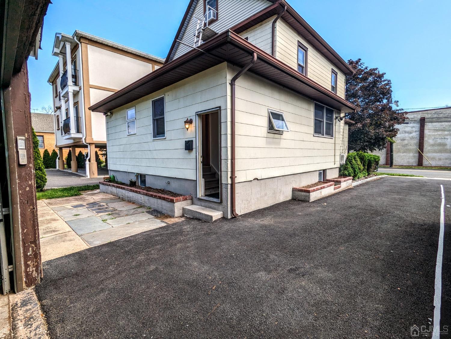 107 Madison Avenue, Unit 2 Dunellen, NJ 08812 - Photo 1 of 18 a view of a house with wooden fence
