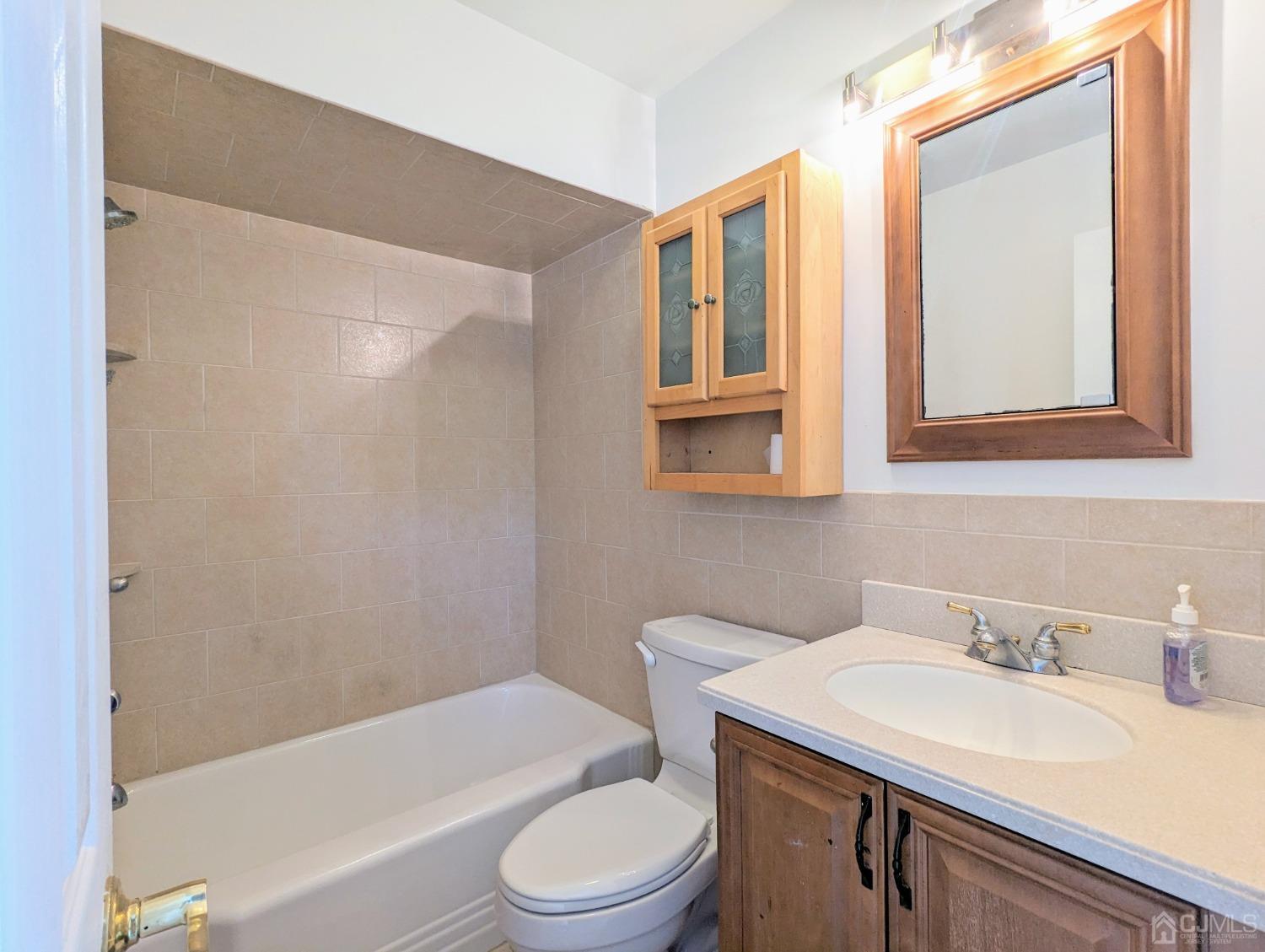 107 Madison Avenue, Unit 2 Dunellen, NJ 08812 - Photo 11 of 18 a bathroom with a sink toilet and shower