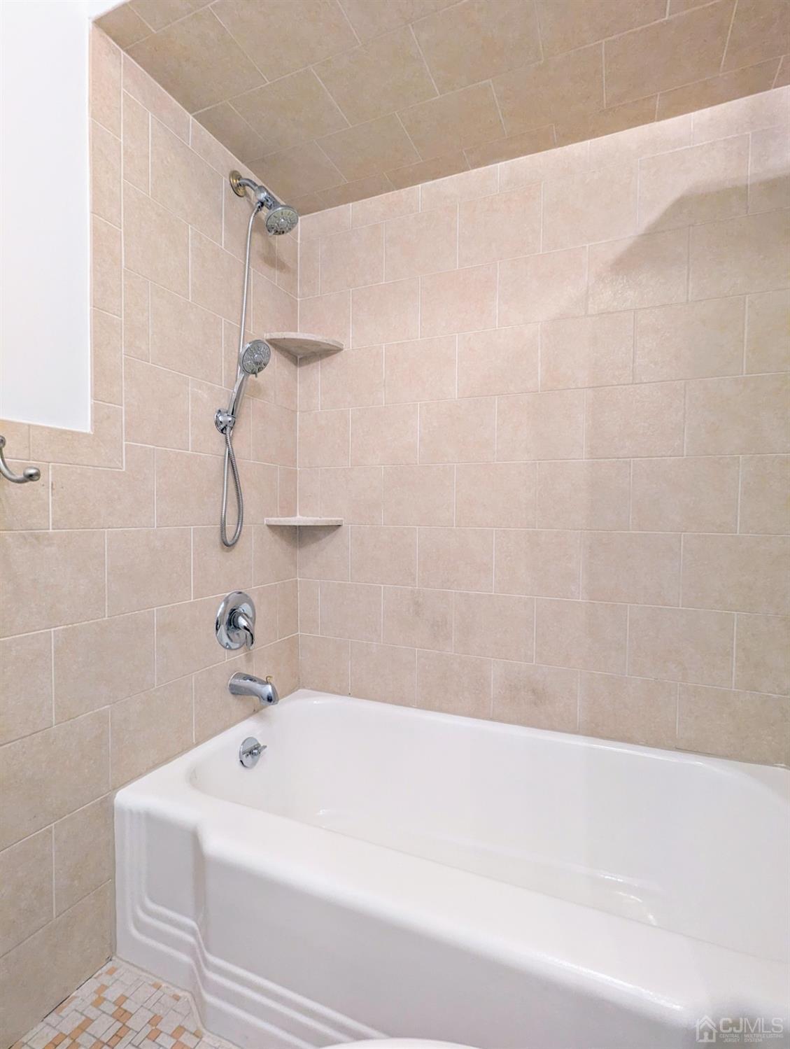 107 Madison Avenue, Unit 2 Dunellen, NJ 08812 - Photo 13 of 18 a bathroom with a bathtub
