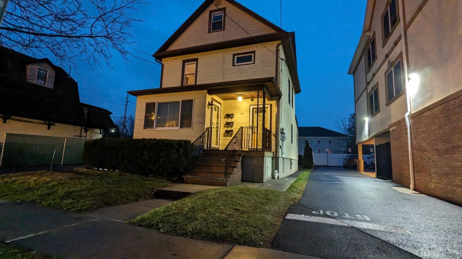 107 Madison Avenue, Unit 2 Dunellen, NJ 08812 - Photo 17 of 18 a front view of a house with garden