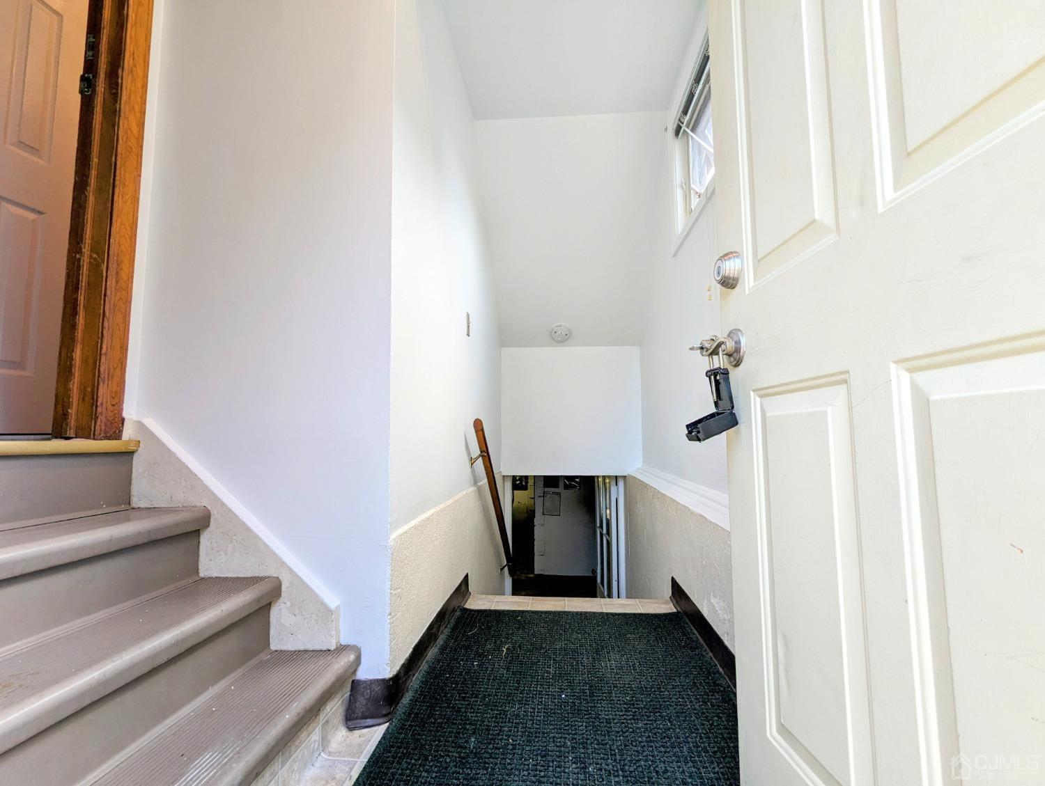 107 Madison Avenue, Unit 2 Dunellen, NJ 08812 - Photo 2 of 18 a view of entryway and hall with wooden floor