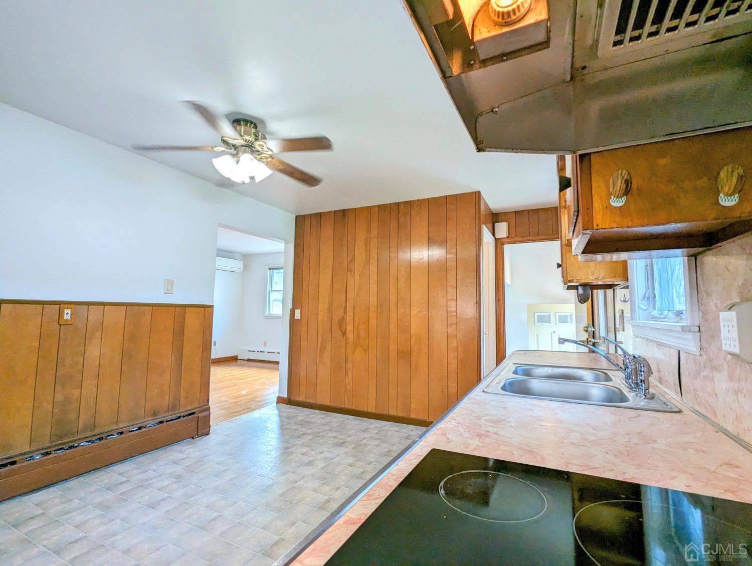 107 Madison Avenue, Unit 2 Dunellen, NJ 08812 - Photo 4 of 18 a view of a kitchen with a sink and a rug