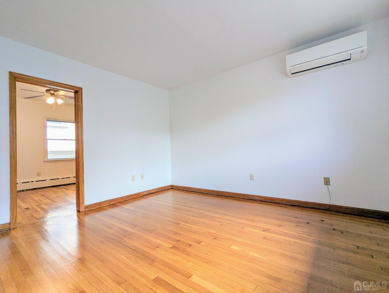 107 Madison Avenue, Unit 2 Dunellen, NJ 08812 - Photo 8 of 18 a view of an empty room and wooden floor